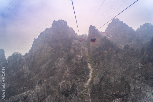 Capture the serene and majestic beauty of Wudang Mountain from the cableway. Perfect for travel and nature themes. photo