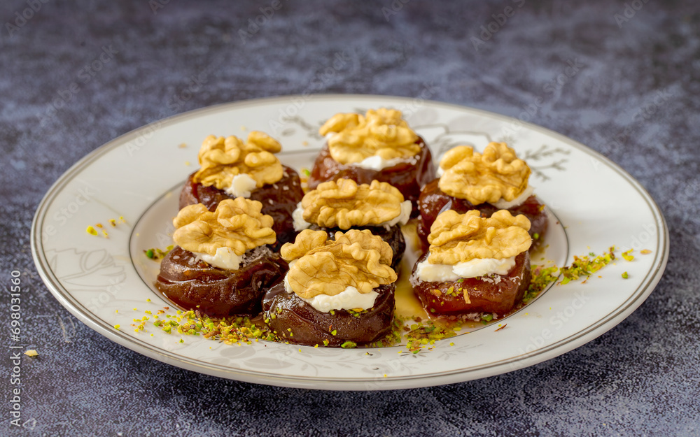 Traditional stuffed dried fig dessert with walnuts and cream, cooked with syrup (Turkish name: fig dessert with cream). Traditional stuffed dried fig dessert with walnuts and cream, cooked with syrup (Turkish name: fig dessert with cream).