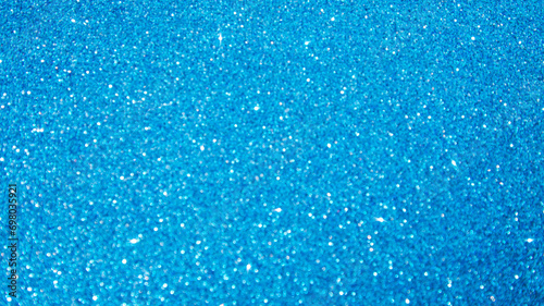 Shining sparkling blue blurred background for holiday design. Christmas abstract sparkles
