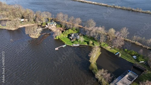 Drone footage of the lakefront houses and moored boats on Reeuwijkse plassen lake in the Netherlands photo