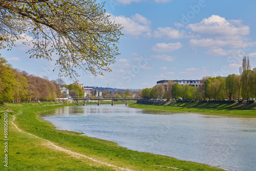 embankment of the river uzh. wonderful urban scenery in summer. view from beneath the shadow of a linden tree branches. photo