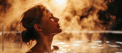 Woman unwinding in a steam room photo