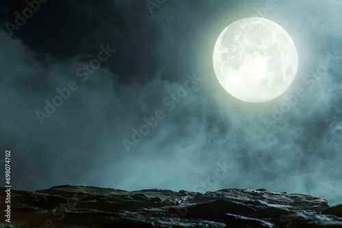 Large full moon - Halloween concept - Full moon casting it's moonlight on a empty stone cliff - with empty space for text - Spooky horror night scene - ethereal mist - foggy and smokey  photo