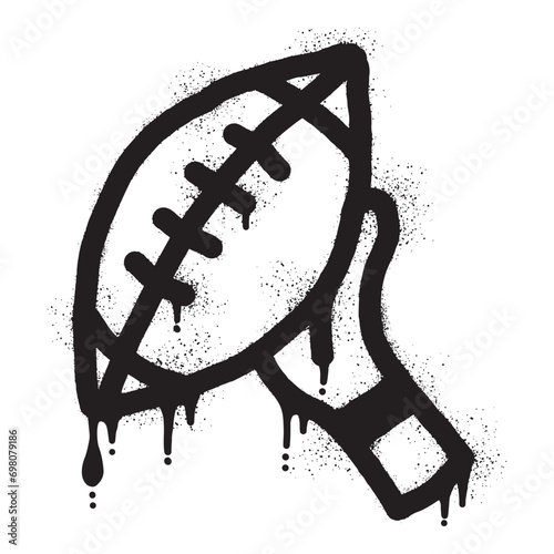 Graffiti of hands holding an American football ball with black spray paint photo