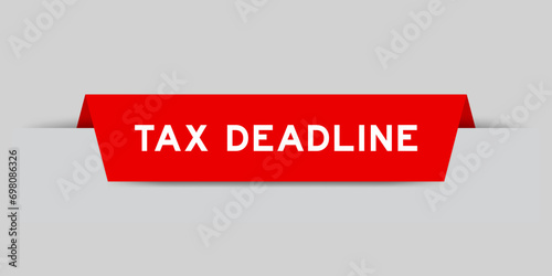 Red color inserted label with word tax deadline on gray background