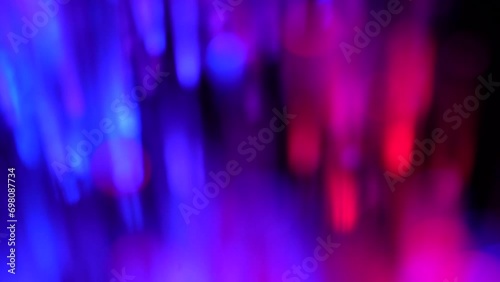 Beautiful thin glowing sticks in blue wiggle on a black background photo