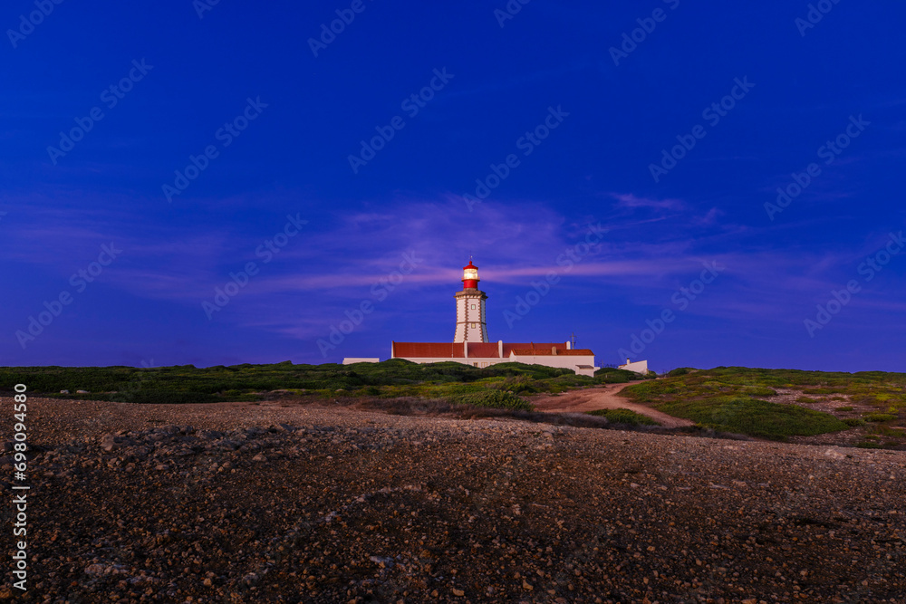 Cape Espichel and working lighthouse at sunset, Portugal