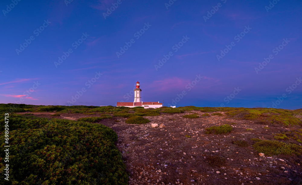 Beautiful sunset of cape Espichel and working lighthouse, Portugal