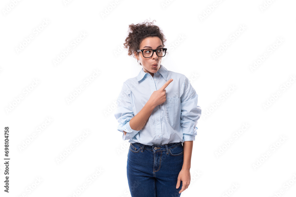portrait of a young slender curly brunette assistant woman dressed in a basic blue shirt and jeans portrait of a young slender curly brunette assistant woman dressed in a basic blue shirt and jeans