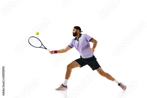Dynamic image of bearded athletic man, tennis player in motion with racket during game, practicing isolated over white background. Concept of professional sport, movement, competition, action. Ad