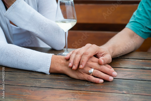 Close-up of couple touching hands showing love and care