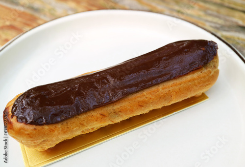 Closeup of Delectable Chocolate Eclair on a White Plate