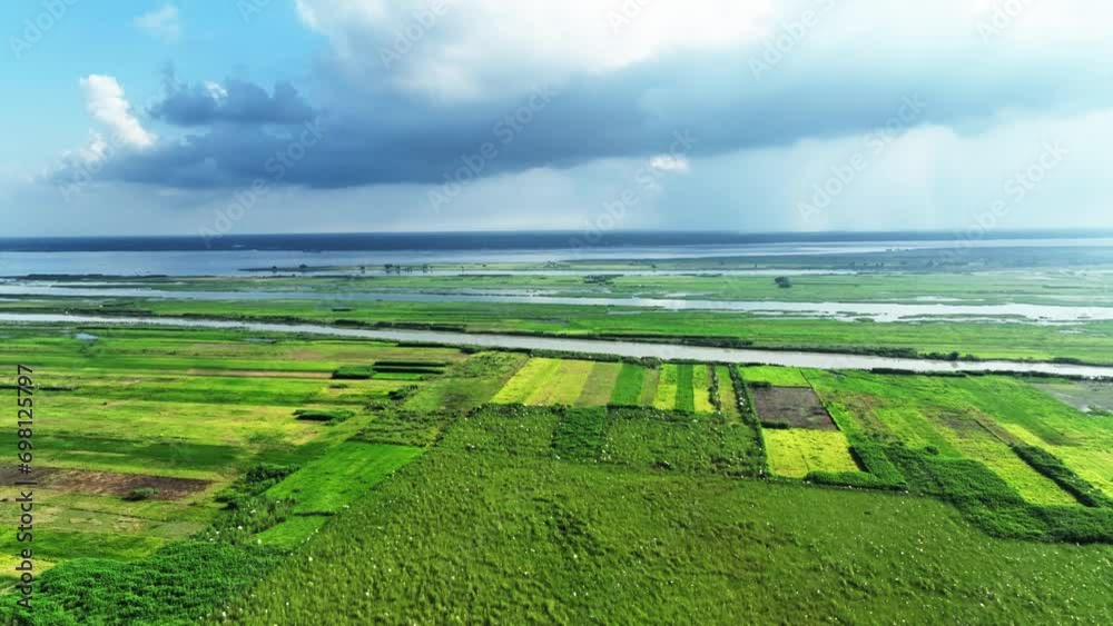 Green fields and a clear blue sky make up the stunning landscape in this aerial view