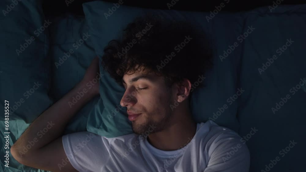 Annoyed arabic young man suffering from insomnia, awake in bed at night, unable sleep. Restless people.