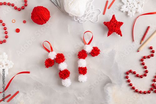 Making pom-poms from red and white threads. Ideas of Christmas decoration diy with kids