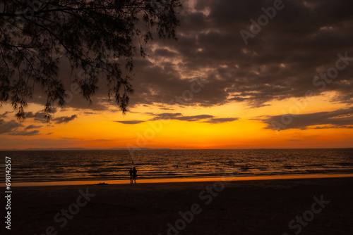 The sea when the sun is about to set The entire horizon is yellow and the foreground is black so that the background is clearly visible.