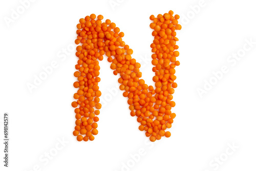The capital letter 'N' formed from red lentil grains against a clean white backdrop. Perfect for a food blog and menu