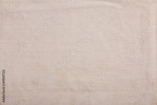 Close-up of organic handmade linen fabric in a natural eggshell hue, showcasing a soft and textured surface