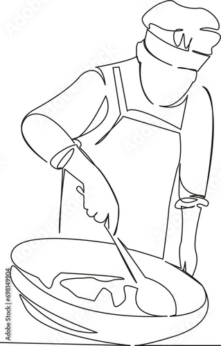the cook prepares pilaf in a cauldron