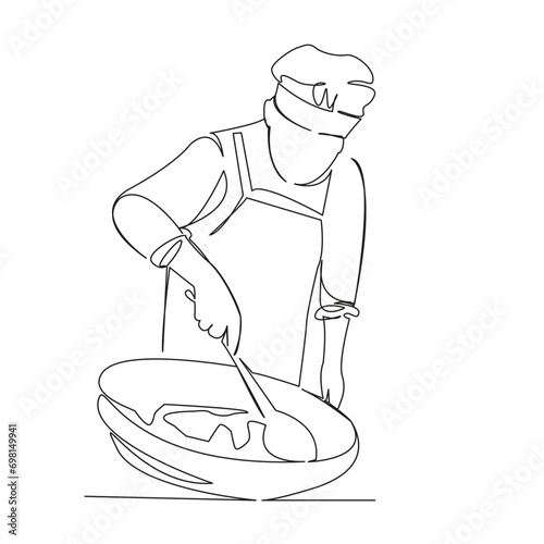 the cook prepares pilaf in a cauldron