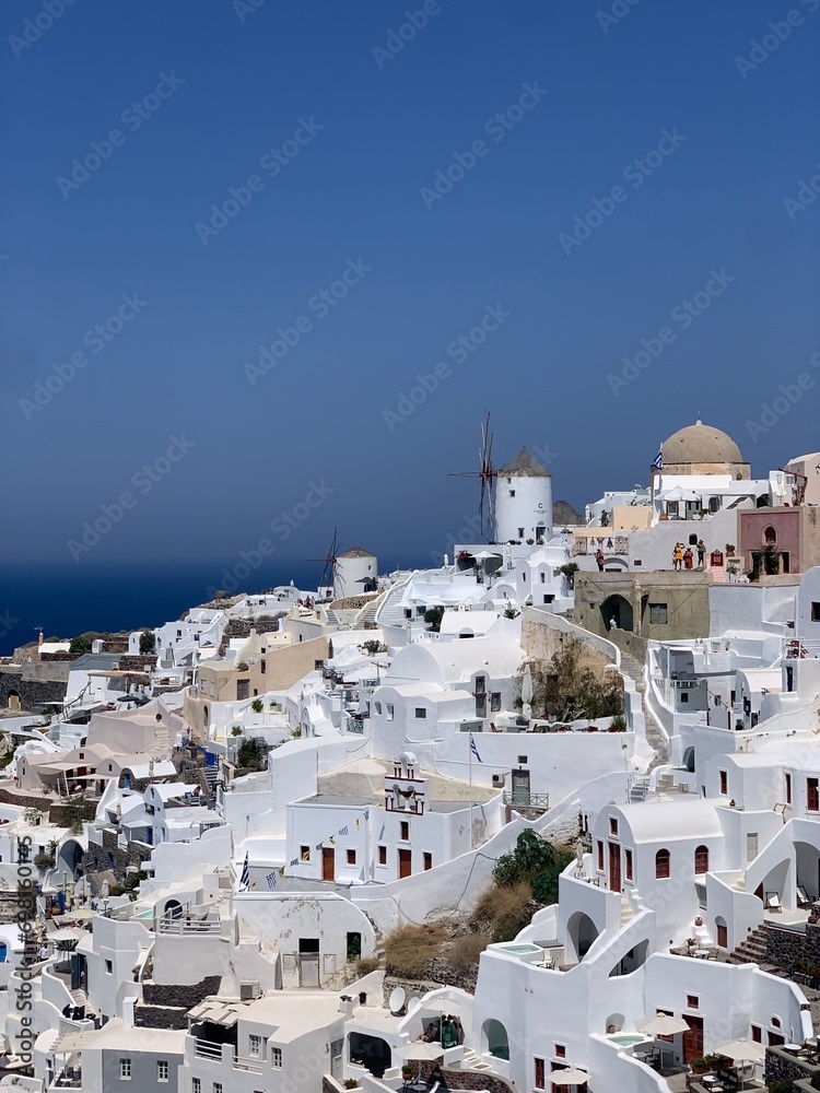 Beautiful Oia town on Santorini island, Greece. Traditional white architecture and greek orthodox churches with blue domes over the Caldera, Aegean sea in the beautiful town of Oia.	