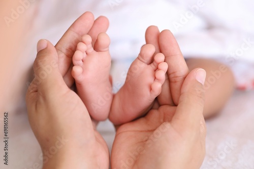 baby feet in hands his  mother  © Mallika