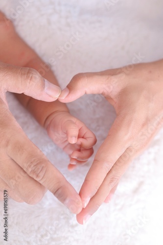 Close up parent and child hands Making a shape of heart.