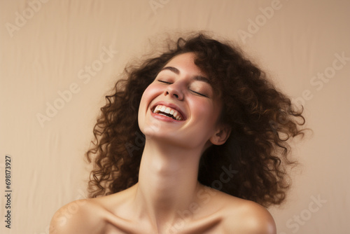 portrait of a beautiful happy smiling young woman isolated on beige background. skin care beauty, skincare cosmetics concept