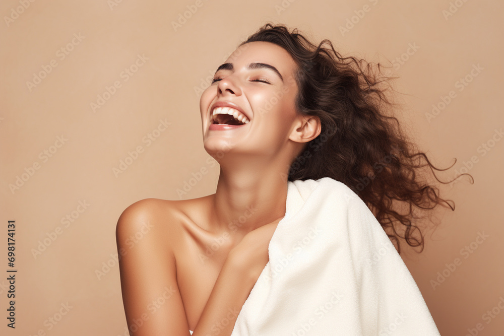 Fototapeta premium portrait of a beautiful happy smiling young woman isolated on beige background. skin care beauty, skincare cosmetics concept