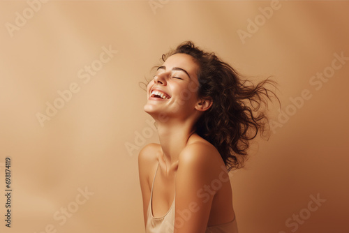 portrait of a beautiful happy smiling young woman isolated on beige background. skin care beauty, skincare cosmetics concept