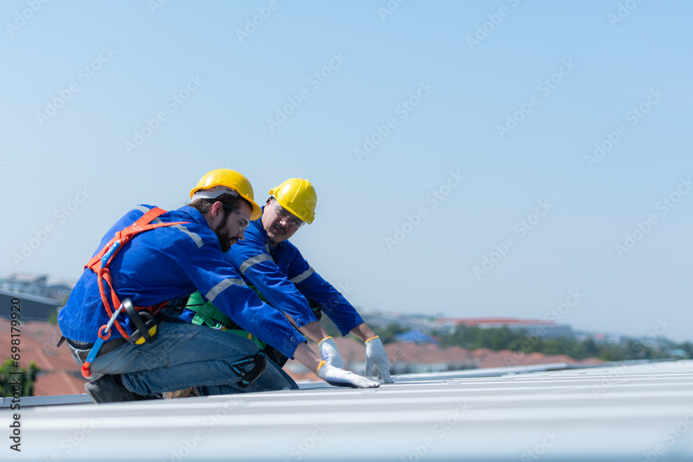 Both of technicians is installing solar panels on the roof of the warehouse to change solar energy into electrical energy for use in factories. Both of technicians is installing solar panels on the roof of the warehouse to change solar energy into electrical energy for use in factories.