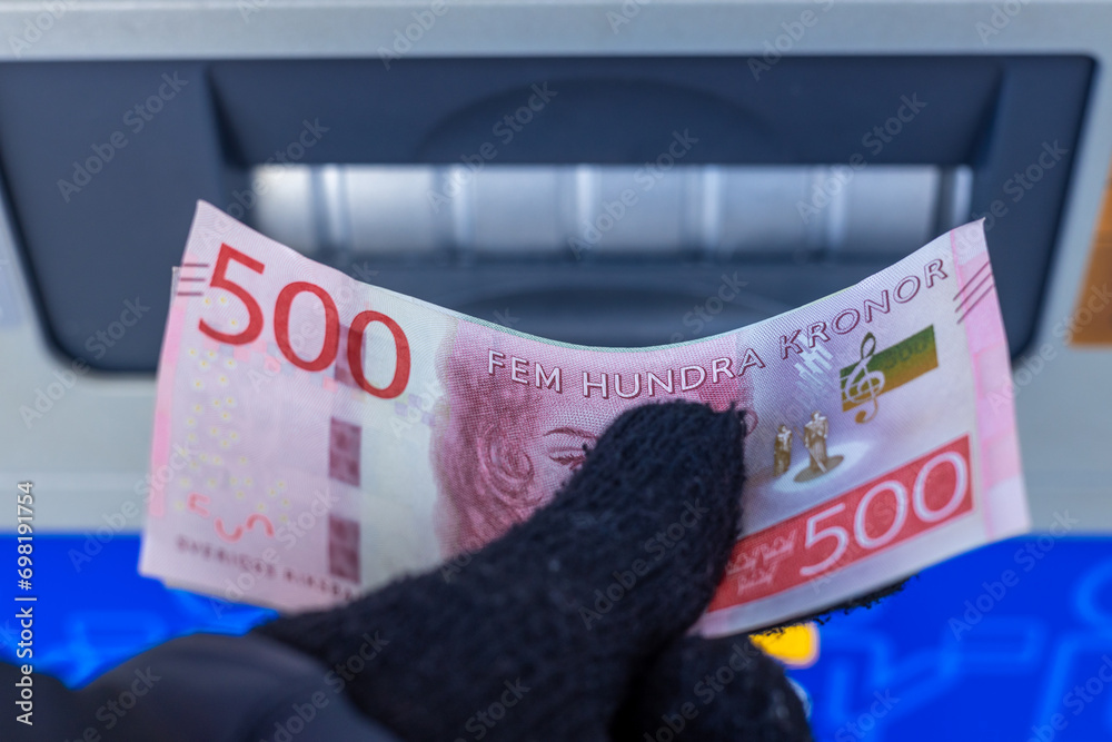 Sweden money, 500 Swedish krona banknote withdrawn from an ATM or inserted into a cash deposit machine, Financial concept, Home budget and cash payments - obrazy, fototapety, plakaty 