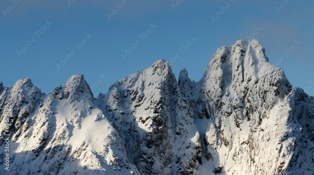 Lofoten winter landscape. Snow covered mountains in a sunny winter day. Lofoten, Northern Norway. 