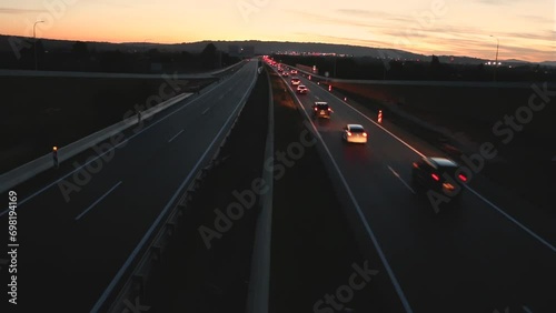 Traffic on a highway at dusk only in one way with no traffic the other way photo