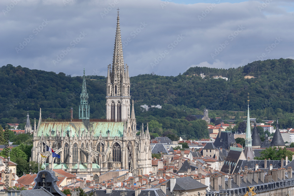 Nancy, France - July 28th 2020 : View of Nancy from the Nancy Cathedral. You can see the Saint-Epvre Basilica, build in Gothic Revival architecture between 1864 and 1874, in front of wooded hill. 