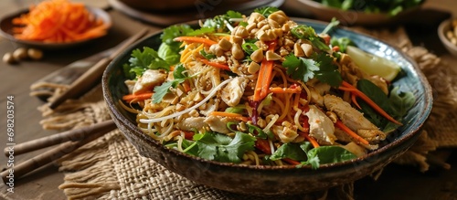 Chicken salad with noodles, carrots, and peanuts in Asian style. photo