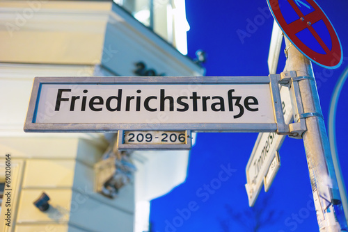 Straßennschild Friedrichstraße am ehemaligen Grenzübergang Checkpoint Charlie in Berlin photo
