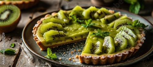 Overhead view of kiwi tart on a plate at home.