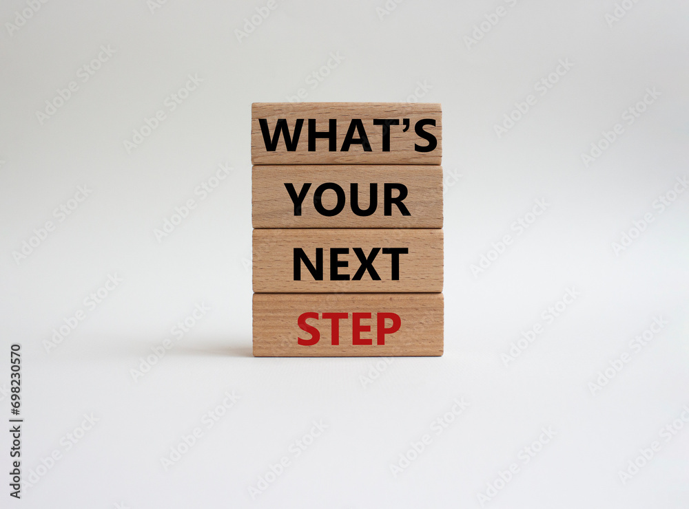 What is your next step symbol. Wooden blocks with words What is your next step. Beautiful white background. Business concept. Copy space. What is your next step symbol. Wooden blocks with words What is your next step. Beautiful white background. Business concept. Copy space.