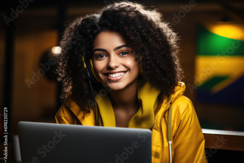 Woman with smile on her face sitting in front of laptop. This image can be used to depict happy person working or enjoying leisure time on computer.
