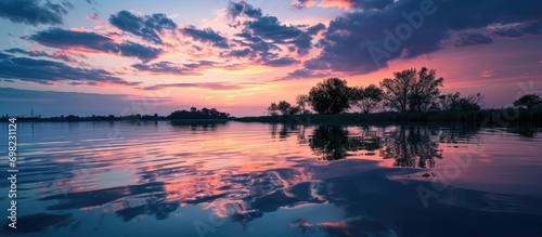 Colorful sky and water reflection during sunrise and sunset, in their natural setting.