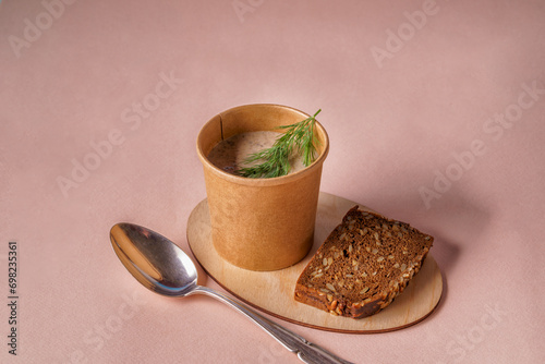 Pea soup in paper disposable cups for take-out or delivery of food,bread,garlic