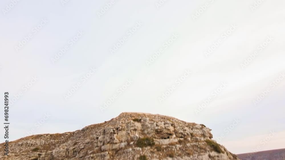 View of red rock mountain, national park. Drone flying through the wilderness. Landscape of arid mountains, racing drone piloting down a cliff View of red rock mountain, national park. Drone flying through the wilderness. Landscape of arid mountains, racing drone piloting down a cliff