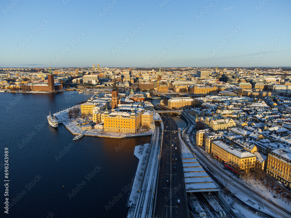 Fototapeta premium Panorama of the old town of Stockholm, island of Riddarholmen and district of Kungsholmen, in winter with snow and sunshine.