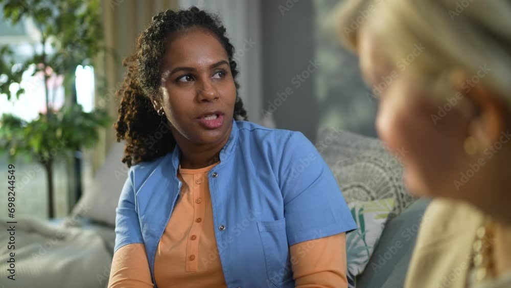 Senior woman talking to caregiver at home Senior woman talking to caregiver at home