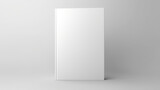 Blank white book resting on plain surface. Suitable for various uses.