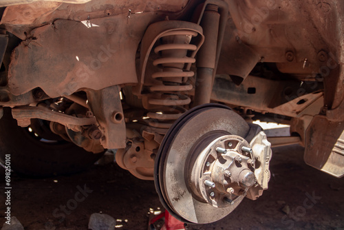 Vehicle front strut and axel in auto service mechanical workshop