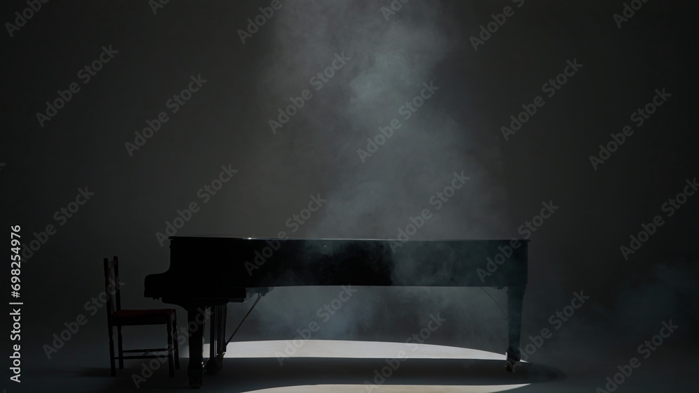 Close up shot of classical piano. Beautiful black piano standing in the studio on white background, low light with smoke over it. - obrazy, fototapety, plakaty 