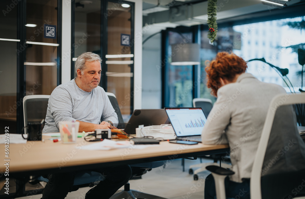 Diverse professionals collaborate in an office, discussing strategies, reviewing stats. Focused on achieving financial growth and profit with enjoyable teamwork.