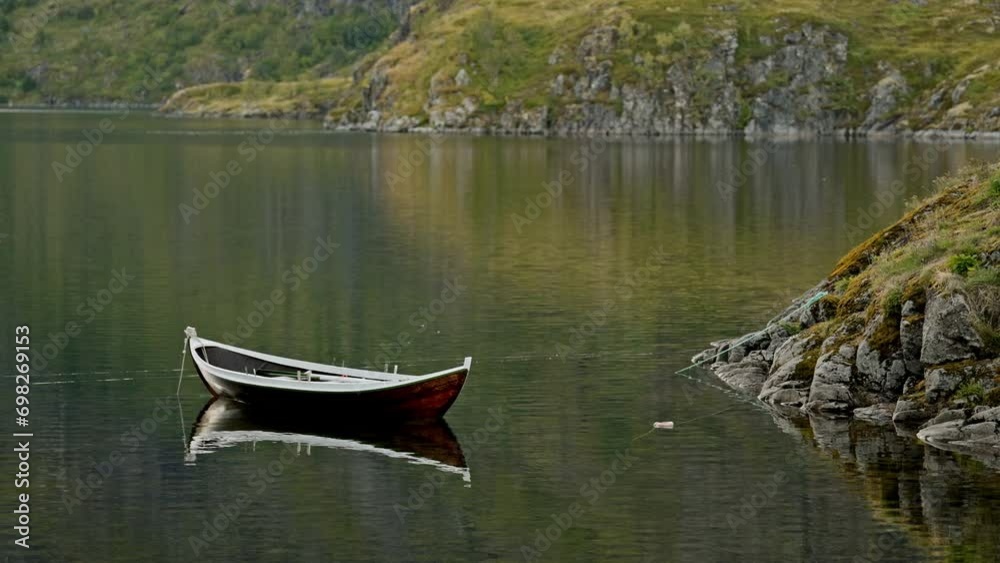 Still Boat On Lake With Rugged Shoreline Still Boat On Lake With Rugged Shoreline